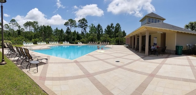 pool with fence and a patio