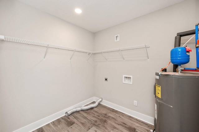 laundry room with hardwood / wood-style floors, hookup for a washing machine, electric water heater, and hookup for an electric dryer