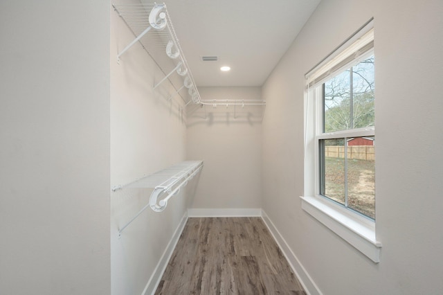 spacious closet featuring hardwood / wood-style floors