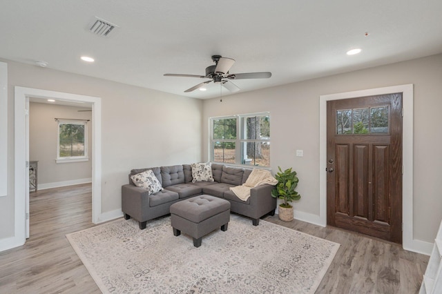 living room featuring ceiling fan and light wood-type flooring