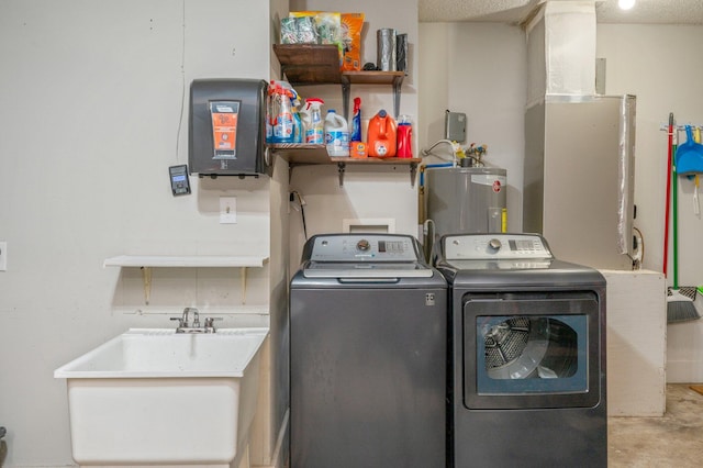 clothes washing area with electric water heater, sink, a textured ceiling, and independent washer and dryer