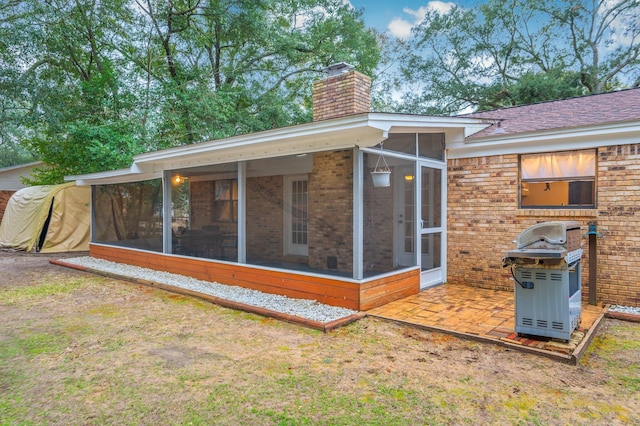 back of property with a sunroom