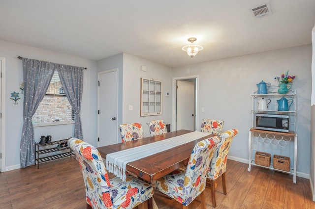 dining area with dark hardwood / wood-style floors