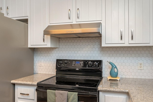 kitchen with white cabinetry, light stone countertops, exhaust hood, and electric range