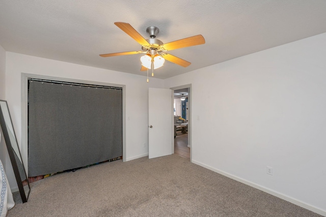 unfurnished bedroom with ceiling fan and light carpet