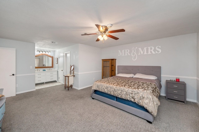 carpeted bedroom with connected bathroom and ceiling fan