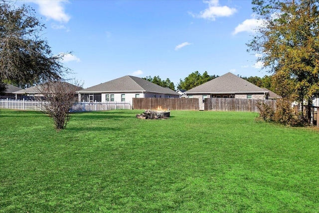 view of yard with a fire pit