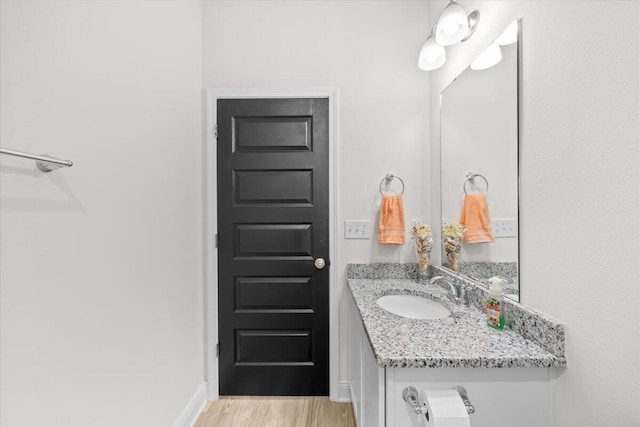 bathroom with vanity and hardwood / wood-style floors