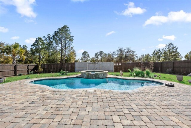 view of pool with a patio area and an in ground hot tub