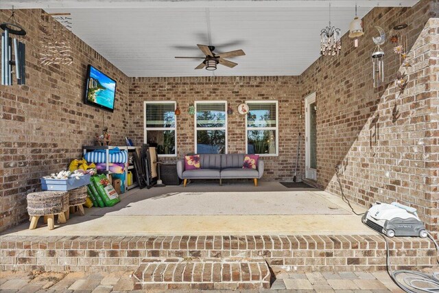 view of patio / terrace with ceiling fan and an outdoor living space