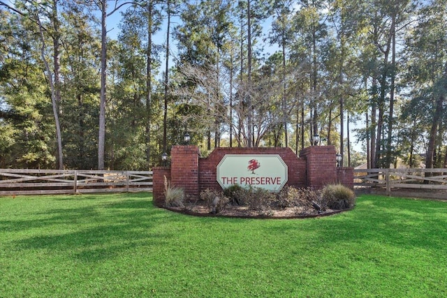 community sign featuring a lawn