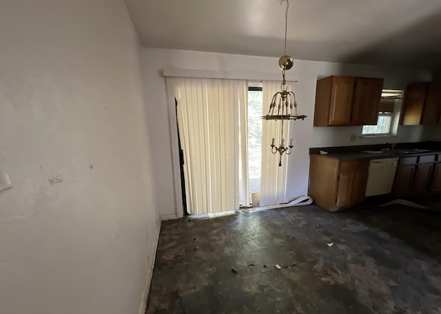 kitchen featuring pendant lighting, plenty of natural light, dishwasher, and sink