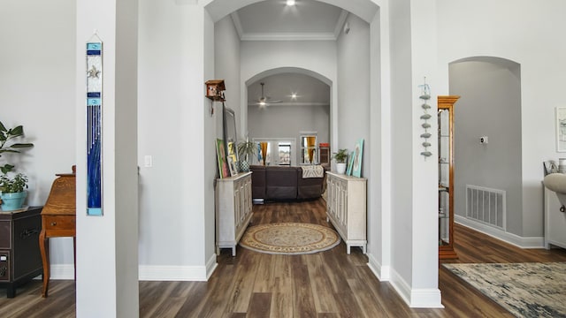 hallway with crown molding and dark wood-type flooring