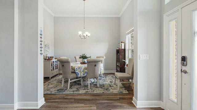 dining room featuring an inviting chandelier, crown molding, and dark hardwood / wood-style floors