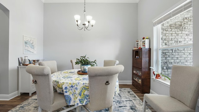 dining space with dark hardwood / wood-style floors and a notable chandelier