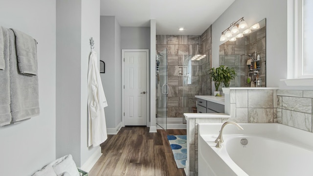 bathroom with vanity, shower with separate bathtub, and wood-type flooring