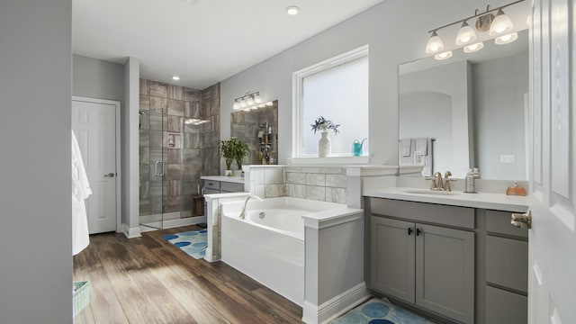 bathroom featuring separate shower and tub, vanity, and wood-type flooring