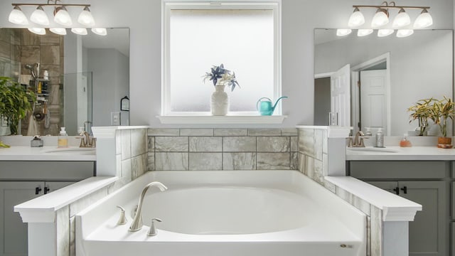 bathroom with vanity and shower with separate bathtub