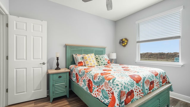 bedroom featuring ceiling fan and dark hardwood / wood-style floors