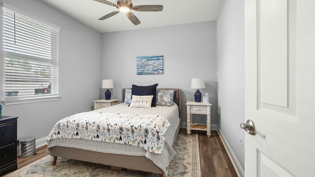 bedroom featuring ceiling fan and dark wood-type flooring