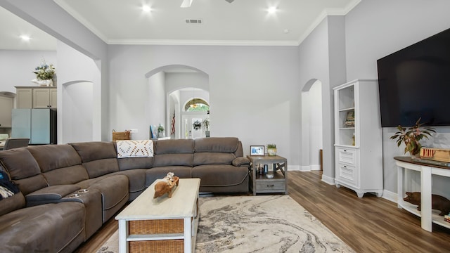 living room with crown molding and dark hardwood / wood-style flooring