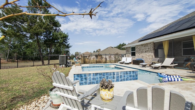 view of swimming pool featuring a patio, a lawn, and an in ground hot tub