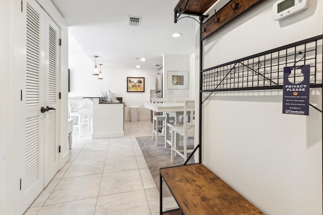 hall with light tile patterned floors