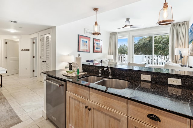 kitchen with light tile patterned flooring, sink, hanging light fixtures, dishwasher, and dark stone counters