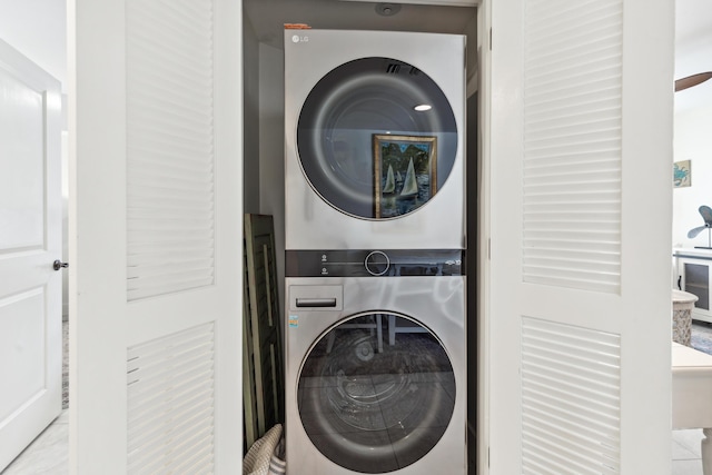 laundry area featuring stacked washer / dryer