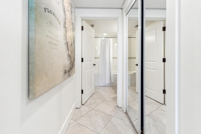 hallway with light tile patterned floors