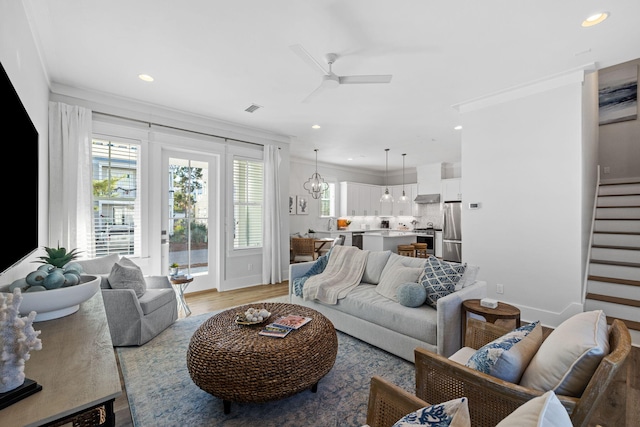 83 Sawgrass Ln, Santa Rosa Beach, FL 32459 - living room featuring ornamental molding, ceiling fan with notable chandelier, and light hardwood / wood-style floors