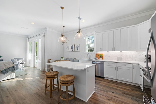 83 Sawgrass Ln, Santa Rosa Beach, FL 32459 - kitchen featuring a kitchen island, pendant lighting, white cabinetry, sink, and stainless steel appliances