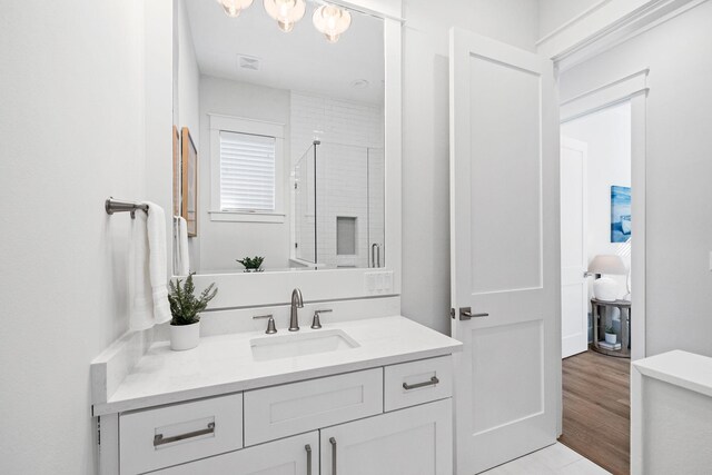 83 Sawgrass Ln, Santa Rosa Beach, FL 32459 - bathroom with vanity, wood-type flooring, and a shower with shower door