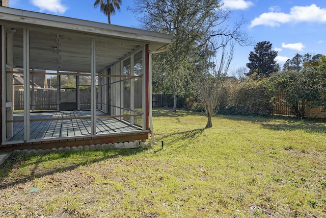 view of yard featuring a sunroom and a fenced backyard