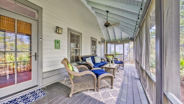 sunroom featuring vaulted ceiling with beams