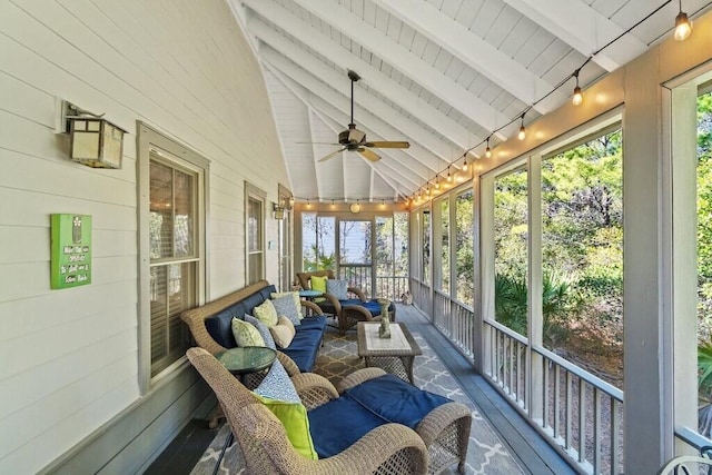 sunroom featuring lofted ceiling with beams and ceiling fan