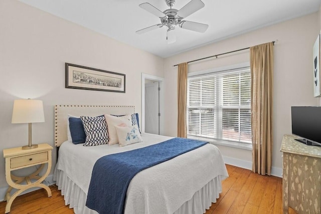 bedroom with ceiling fan and light wood-type flooring