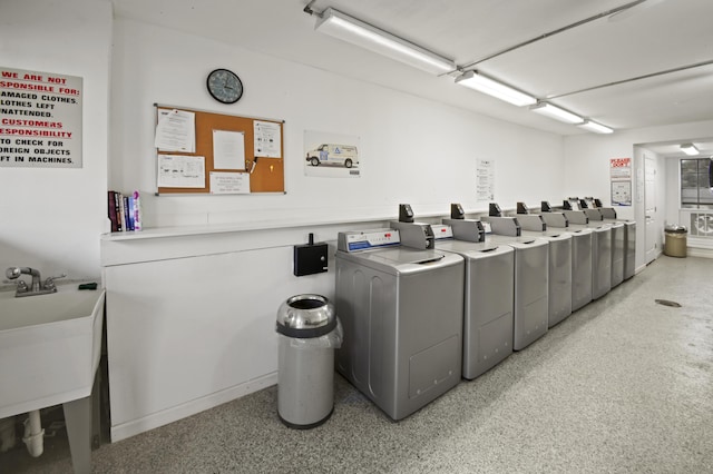 community laundry room featuring washer and dryer and a sink