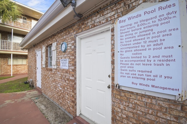 doorway to property with brick siding