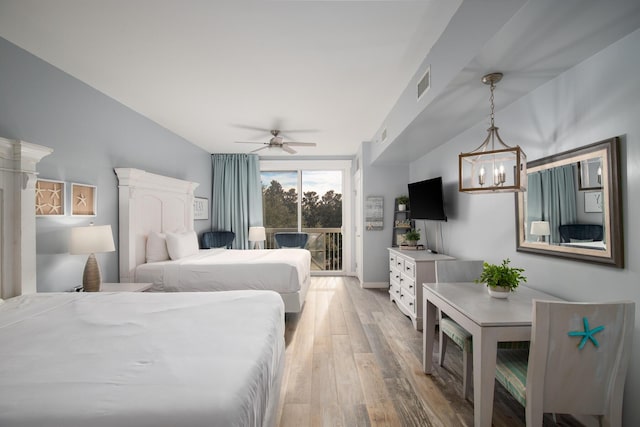 bedroom with a chandelier, light hardwood / wood-style floors, and access to outside