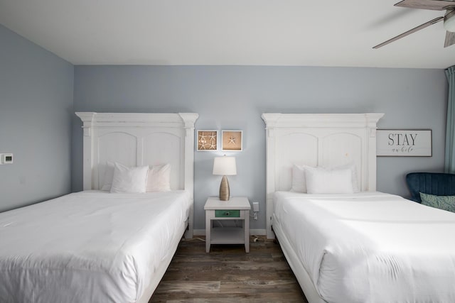 bedroom with dark hardwood / wood-style floors and ceiling fan