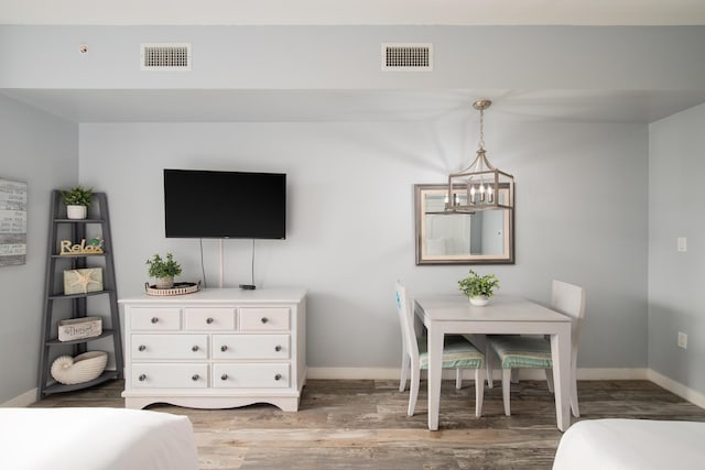 dining area featuring an inviting chandelier and wood-type flooring