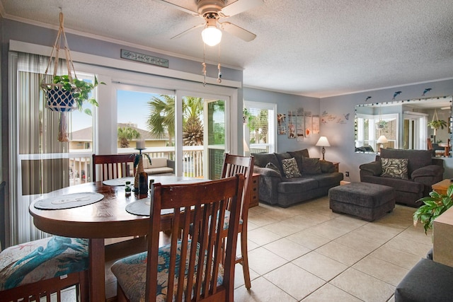 dining space with plenty of natural light, light tile patterned floors, and a textured ceiling