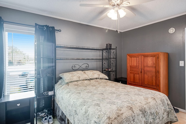 bedroom featuring ceiling fan, ornamental molding, and a textured ceiling