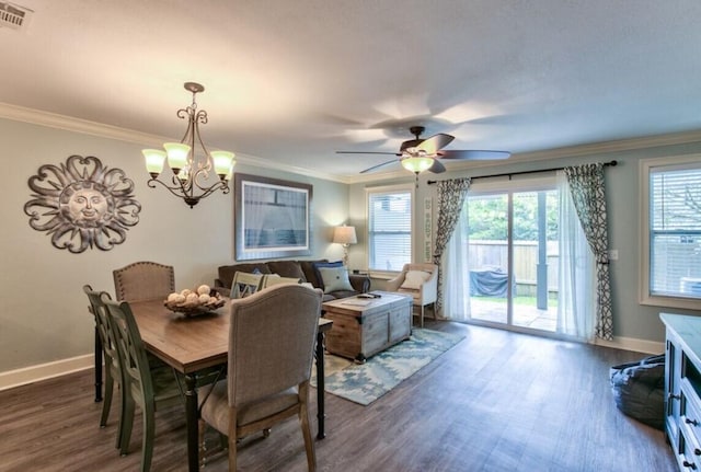 dining area featuring ceiling fan with notable chandelier, dark wood-type flooring, and ornamental molding