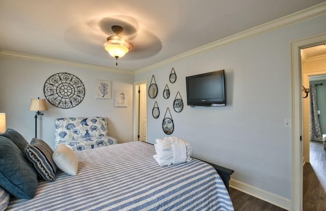 bedroom with ornamental molding, dark hardwood / wood-style floors, and ceiling fan