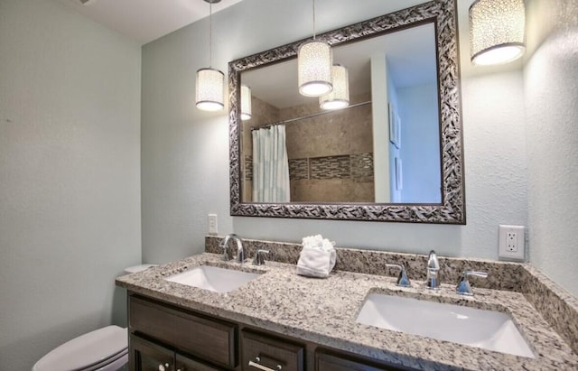 bathroom featuring vanity, walk in shower, and toilet