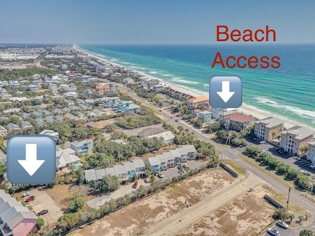 bird's eye view featuring a water view and a beach view