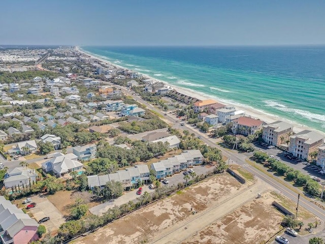 drone / aerial view with a water view and a beach view