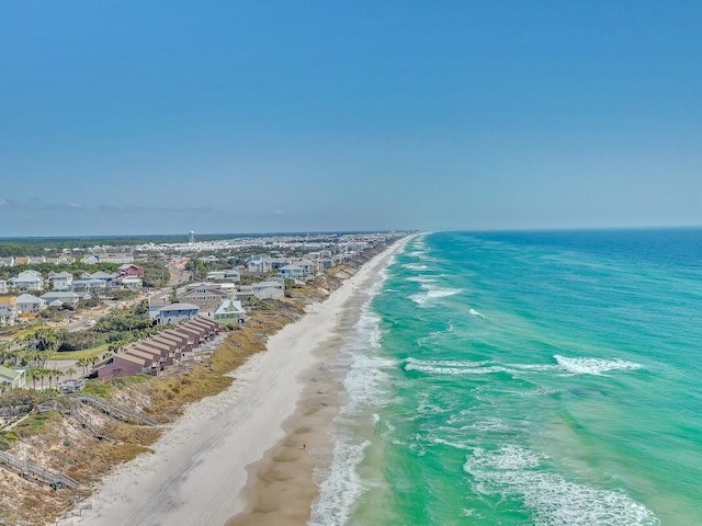 bird's eye view with a water view and a beach view